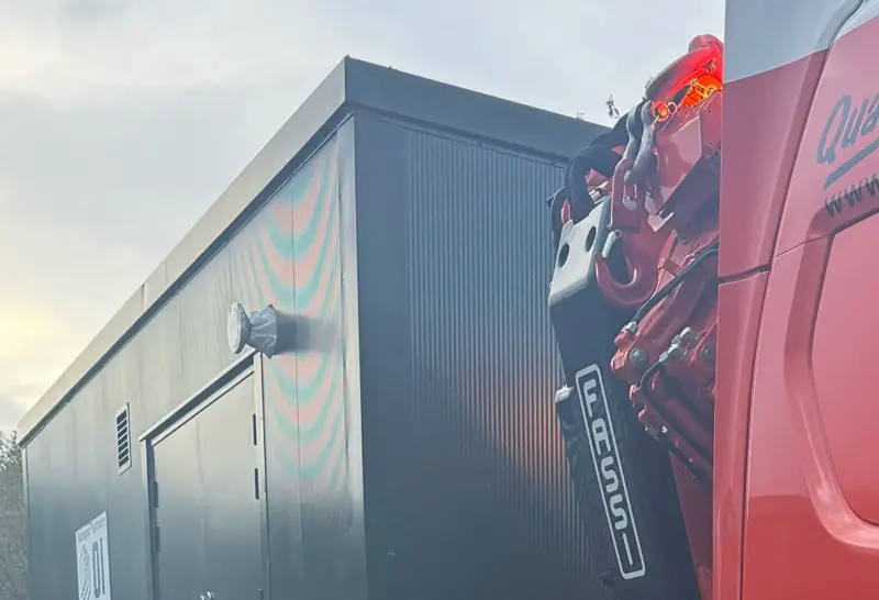 Packaged plant room being lifted into position by a HIAB crane on delivery